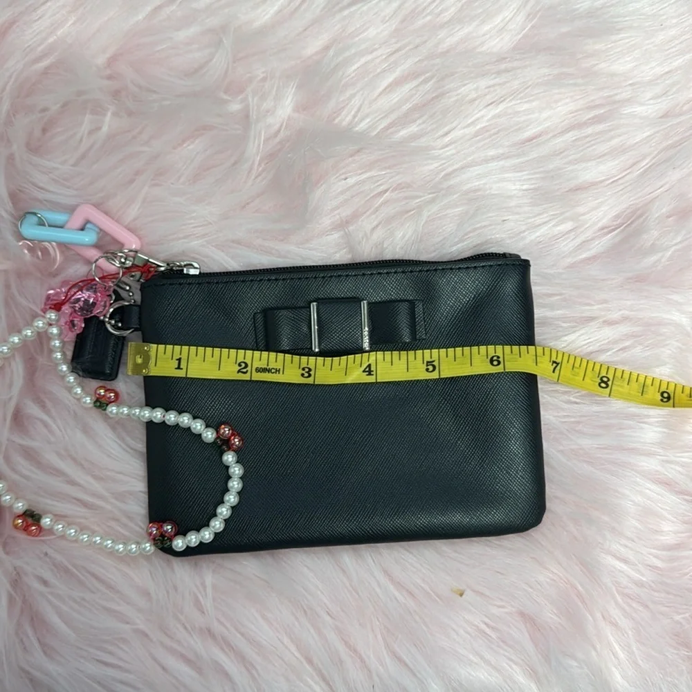 Elegant Black Women's Coach wristlet with bow coquette
